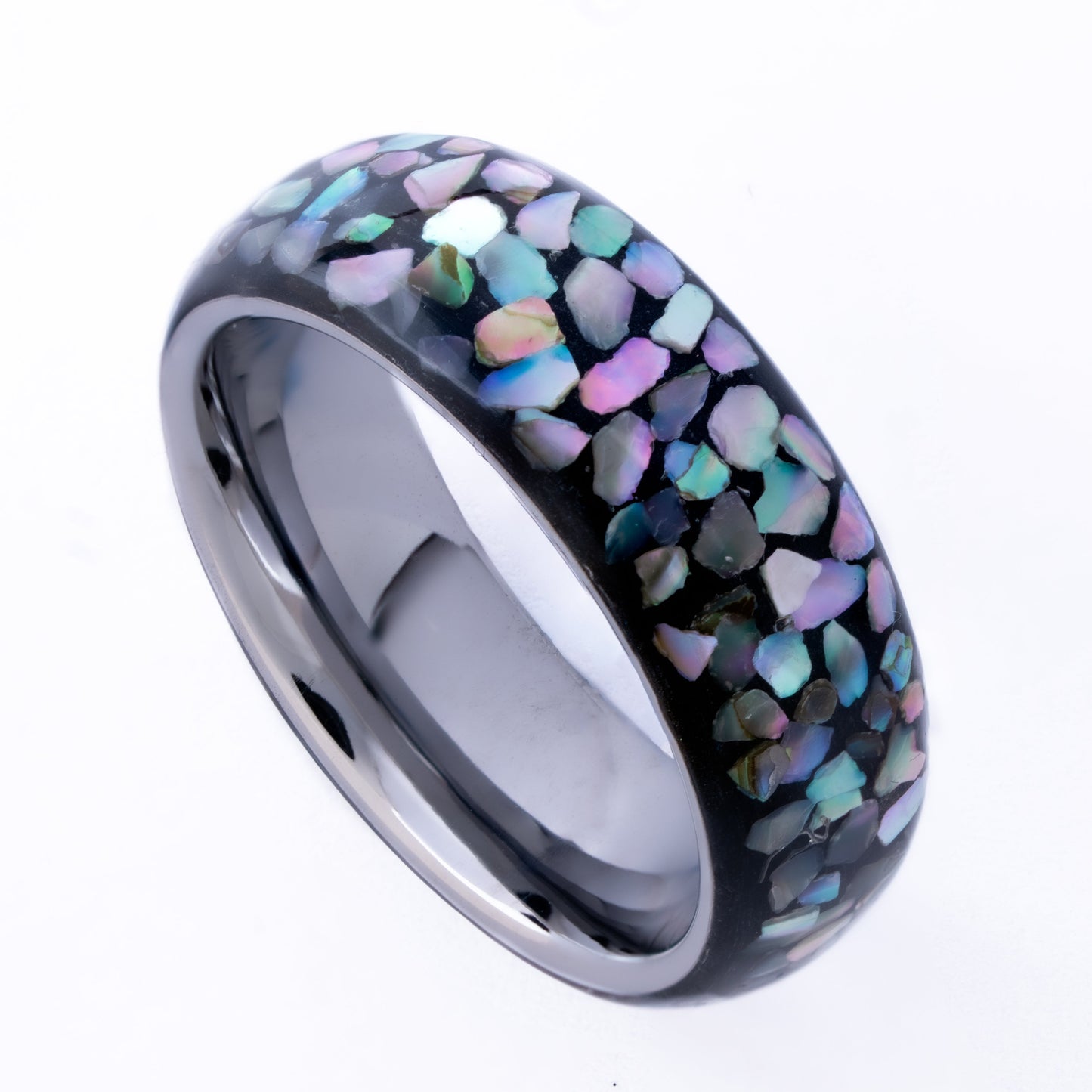 Tungsten ring with multi-color abalone shell pieces on a white background