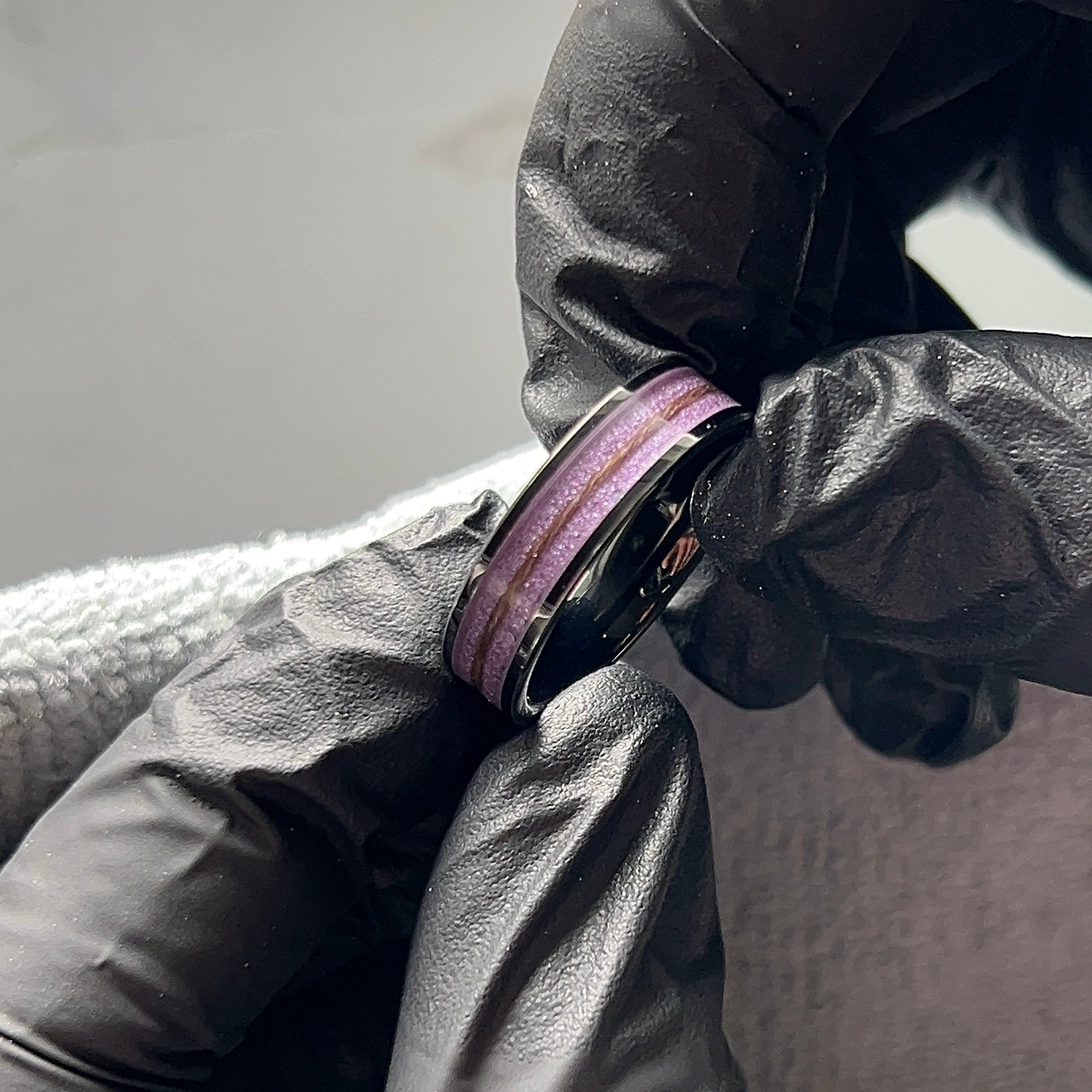 Black plated tungsten ring with purple background and a twist of hair inside