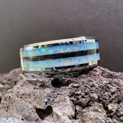 Tungsten ring with three channels, two with a blue and green synthetic opal mix, the middle channel with dark coloured dog fur inside