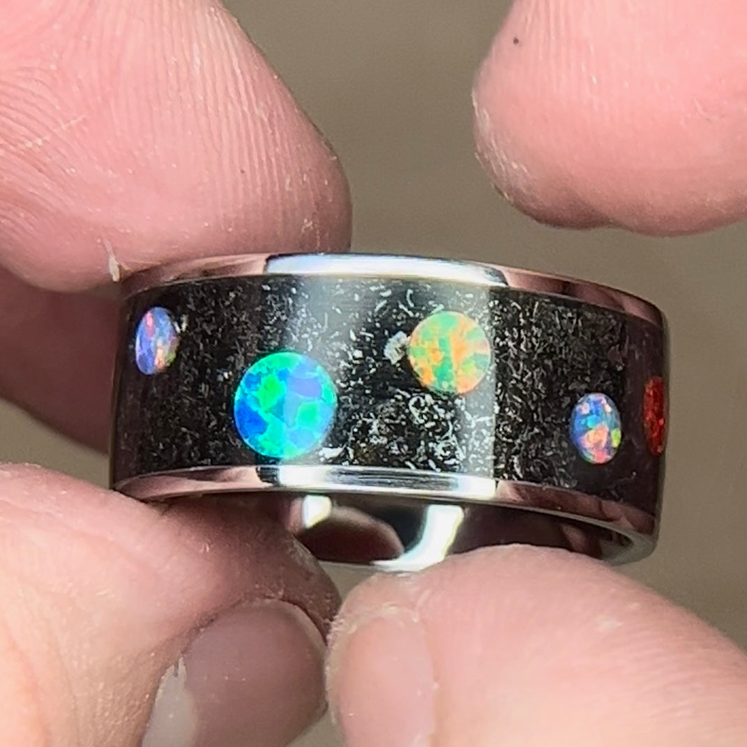 Titanium ring with meteorite shavings and multi-color synthetic opal cabochons to resemble a planet and space design