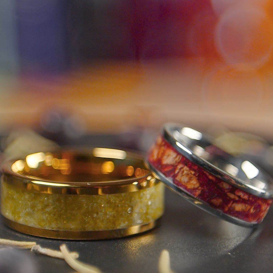Two rings, one with soaked wine cork inside, one with broken wine glass inside, sentimental designs