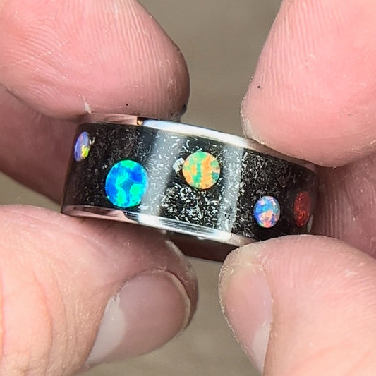 Titanium ring with meteorite shavings and multi-color synthetic opal cabochons to resemble a planet and space design