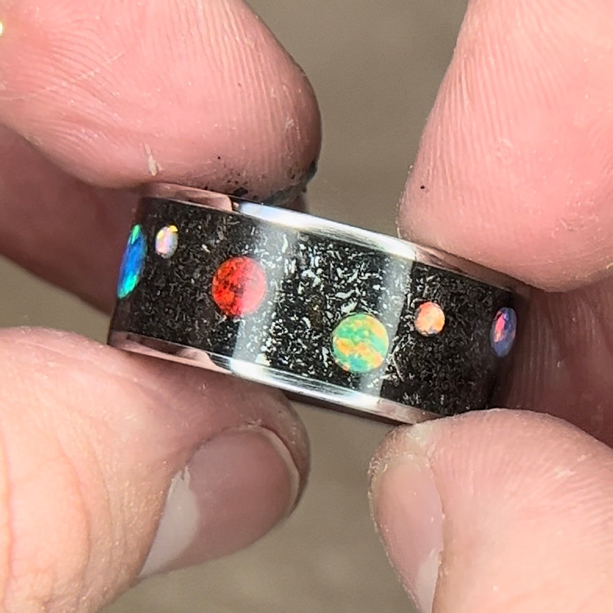 Titanium ring with meteorite shavings and multi-color synthetic opal cabochons to resemble a planet and space design