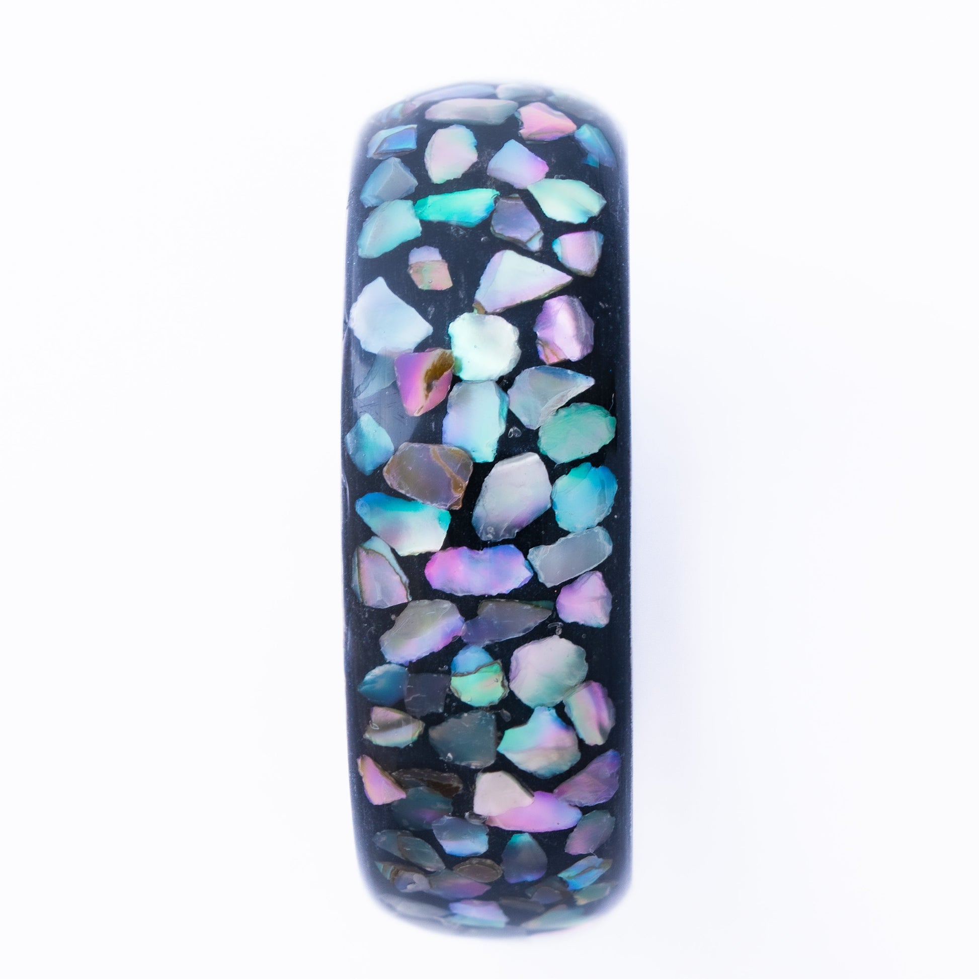 Tungsten ring with multi-color abalone shell pieces on a white background